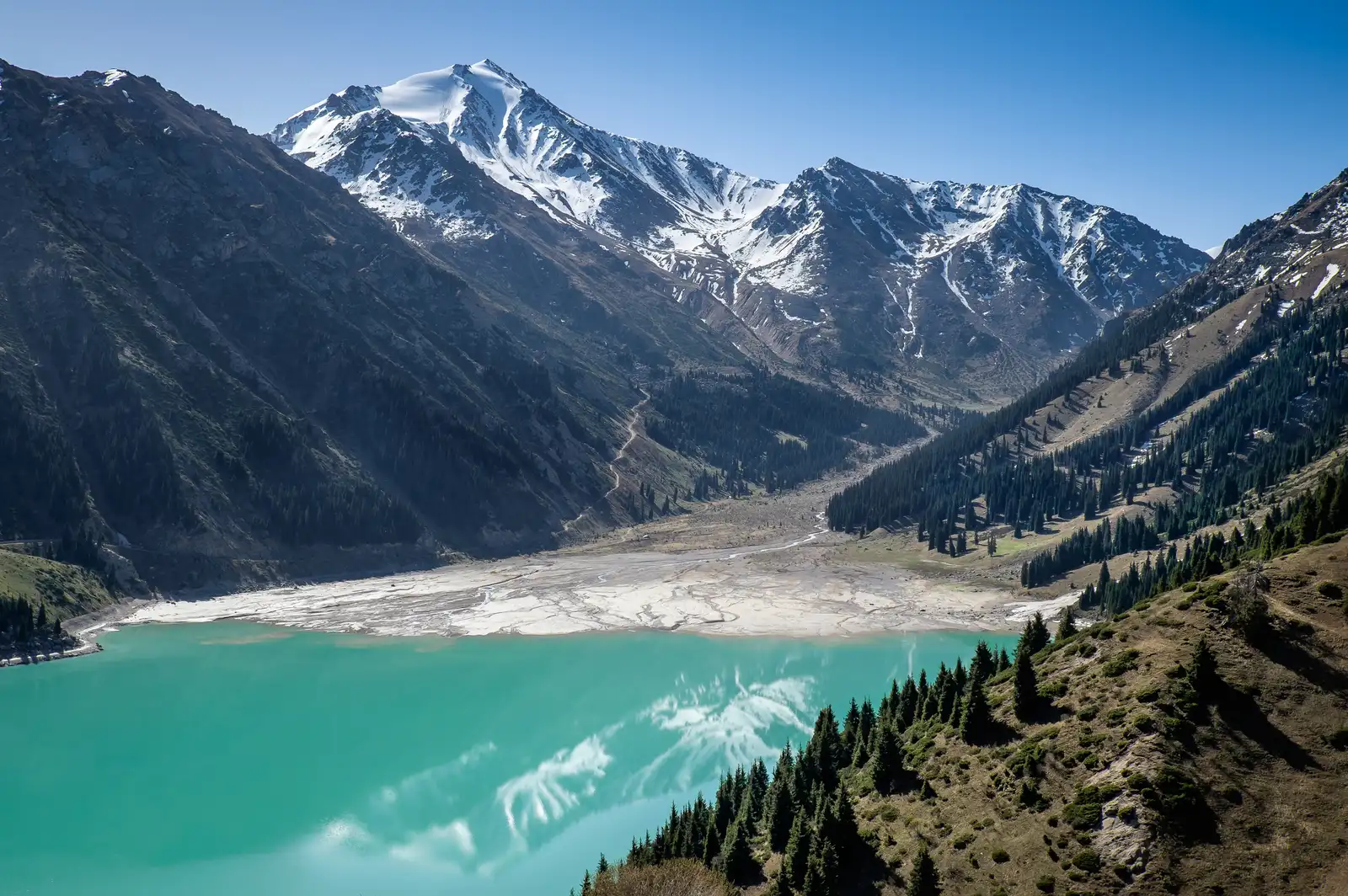 Aerial view of Big Almaty Lake valley with glacier moraine and snow-capped Tien Shan peaks